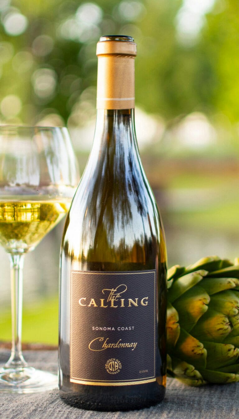 Bottle of 2019 Sonoma Coast Chardonnay resting on table.