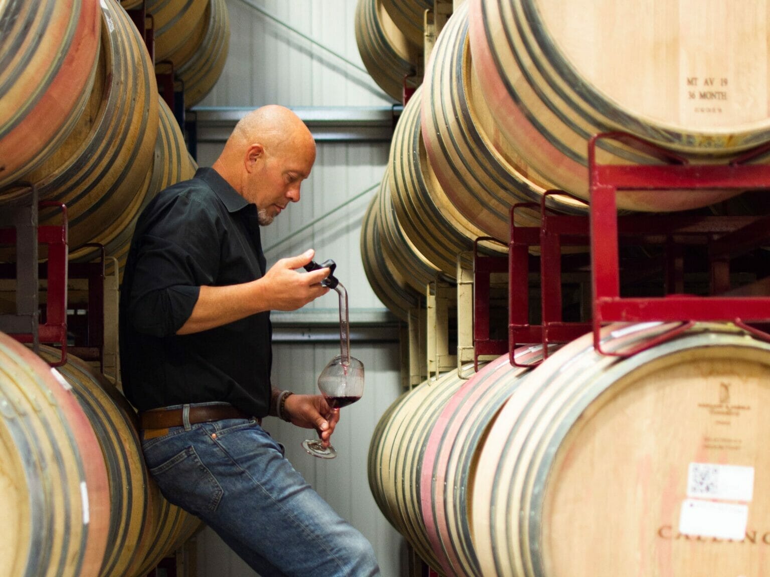 James MacPhail, The Calling's Winemaker, tests his latest vintage around casks of wine - The Calling